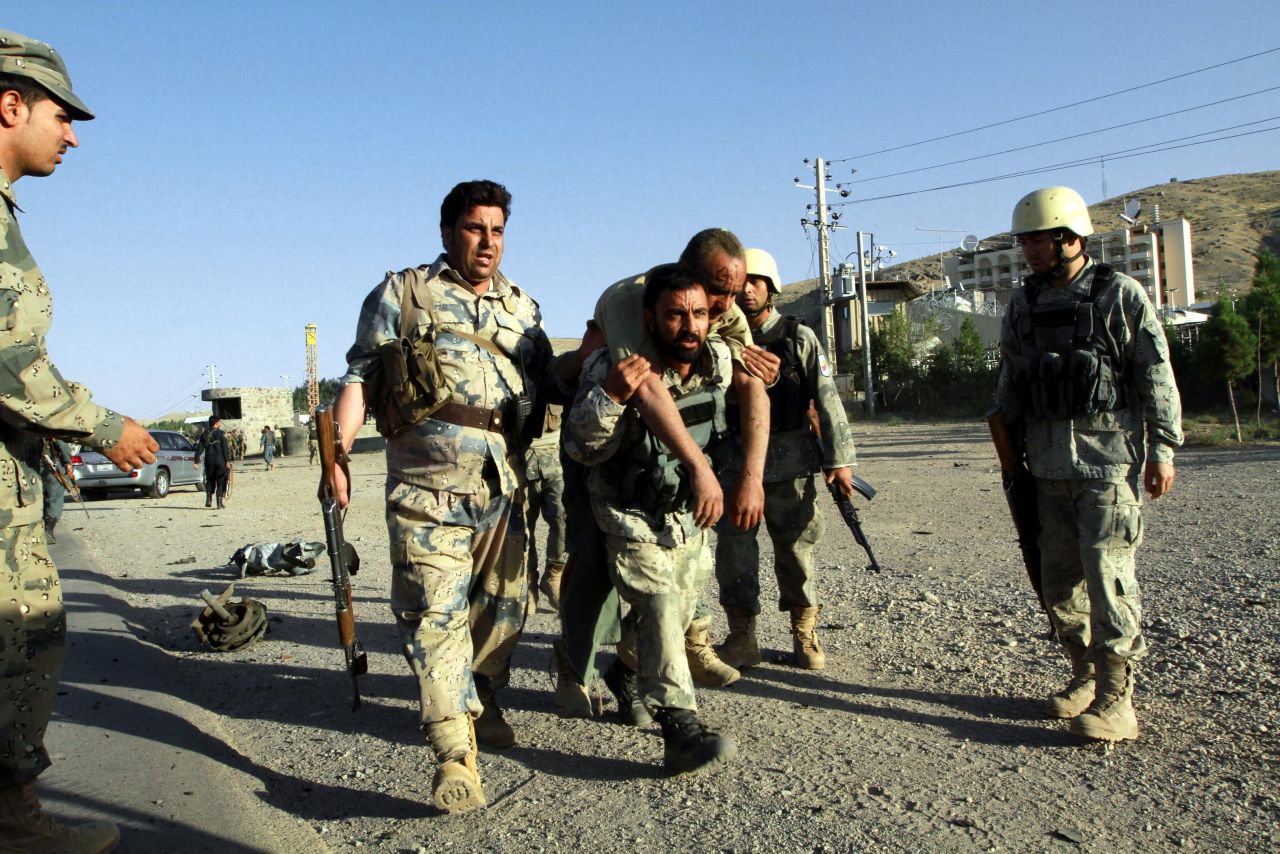 Afghan security officials help an injured colleague at the scene of an attack on September 13. At least three Afghan security officials were killed. The Taliban claimed responsibility for the attack in an e-mail to CNN.