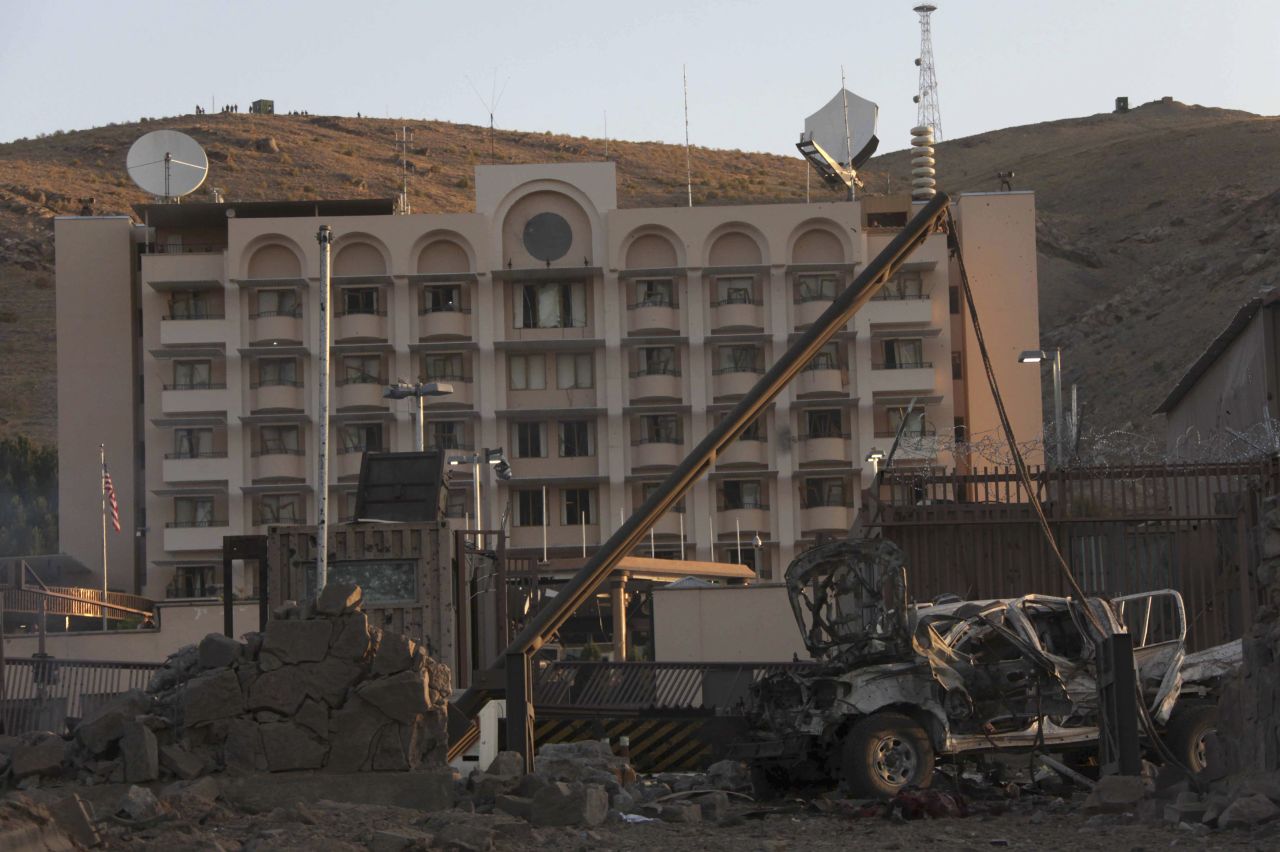 A damaged vehicle sits in front of the U.S. consulate on September 13. American consulate personnel took shelter in safe havens while U.S. security forces responded to the attack, Marie Harf, a deputy State Department spokeswoman, said. There were no U.S. casualties.
