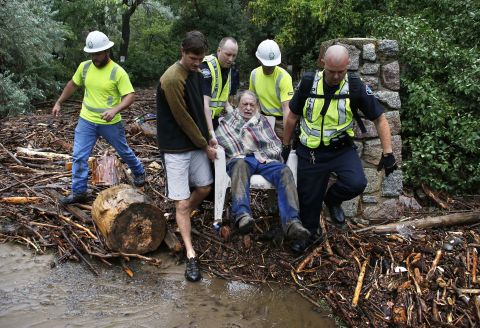 Will Pitner gets rescued by emergency workers and neighbor Jeff Writer on September 13 after he spent a night trapped outside above his home at the base of Boulder Canyon.