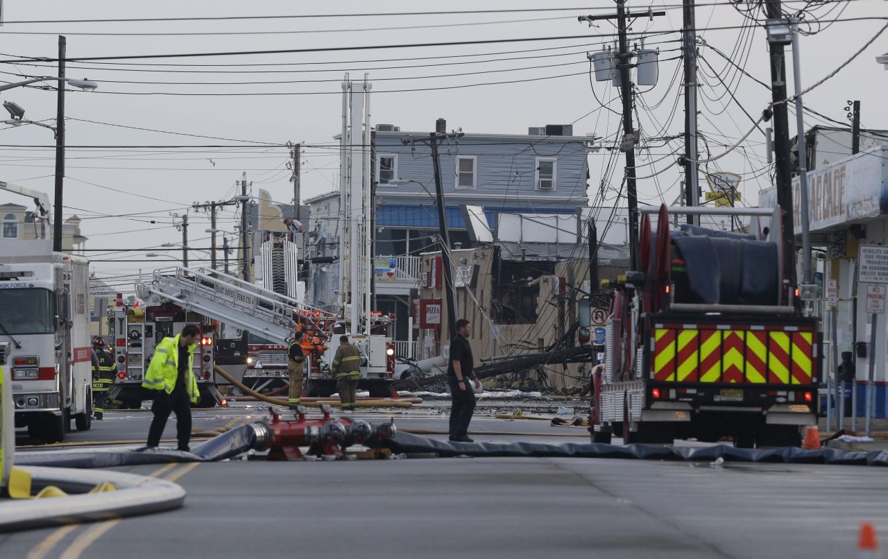 Fire officials work in the area where a massive fire burned a large portion of the boardwalk in Seaside Park, New Jersey, on Friday, September 13. CNN affiliate KYW reported that the fire started Thursday at the Kohr Brothers frozen custard shop on the FunTown Amusement Pier. New Jersey Gov. Chris Christie said 35 engine companies, 15 ladders and 400 firefighters battled the fire. The area is still rebuilding from damage caused by Superstorm Sandy.