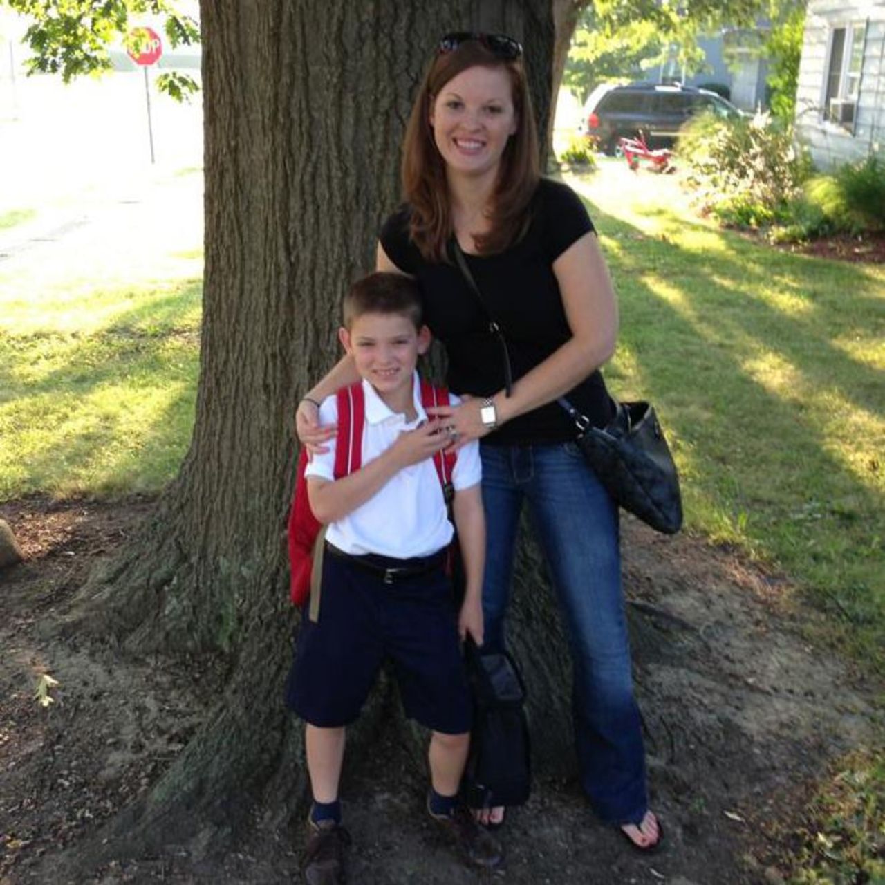 Writer Jessica Crookston poses with her son in their yard on the first day of school this year. Samuel recently started third grade. "Realizing that in 10 years Samuel would be starting college, I felt even more strongly that I had no desire to begin again with a baby," she said.