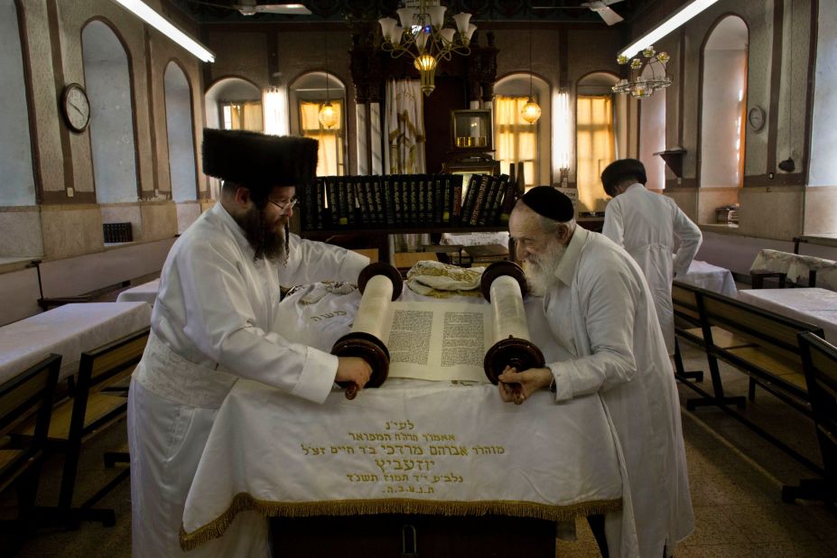 Ultra-Orthodox Jewish men roll a Torah scroll ahead of Yom Kippur in Jerusalem.