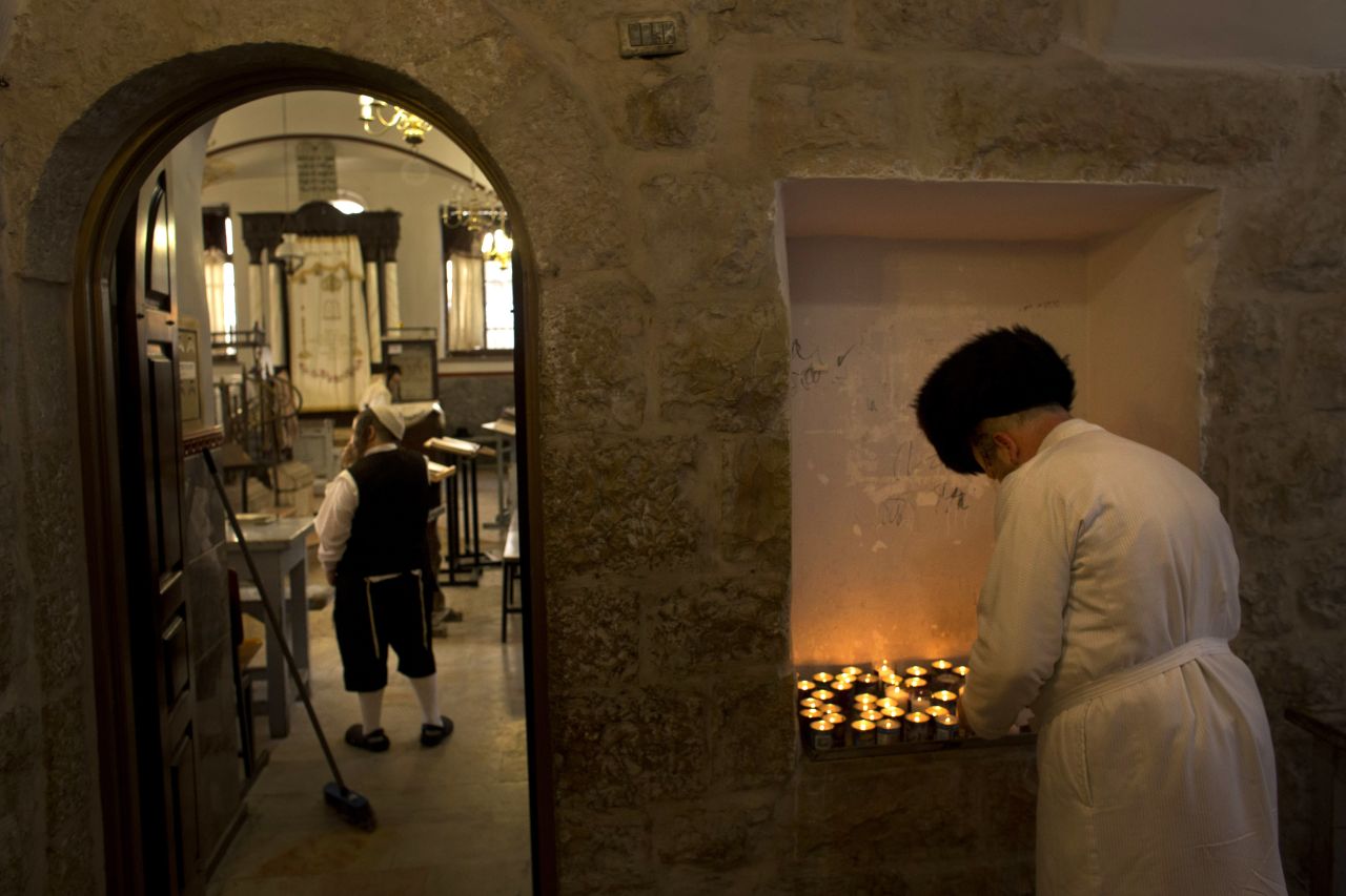 An ultra-Orthodox Jewish man lights a candle ahead of Yom Kippur in Jerusalem.