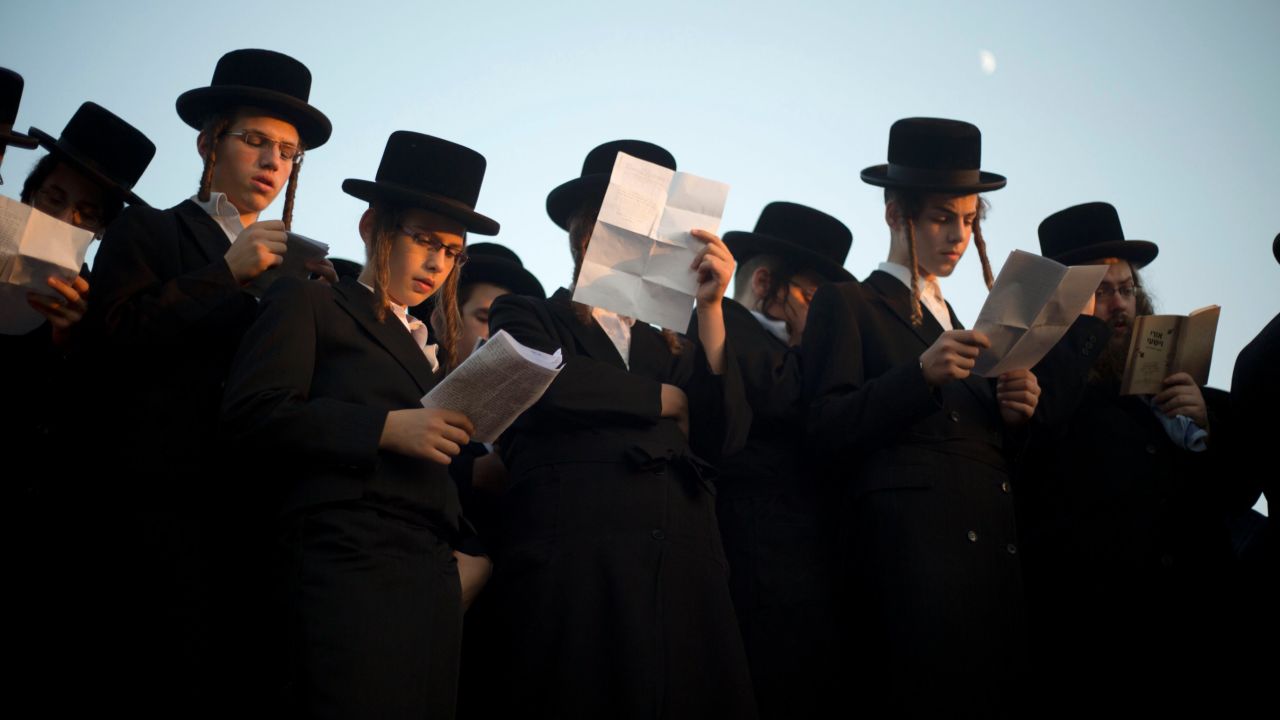 Ultra-Orthodox Jews pray on the Hayarkon river banks as they participate in a Tashlich ceremony in the Israeli town of Ramat Gan near Tel Aviv.