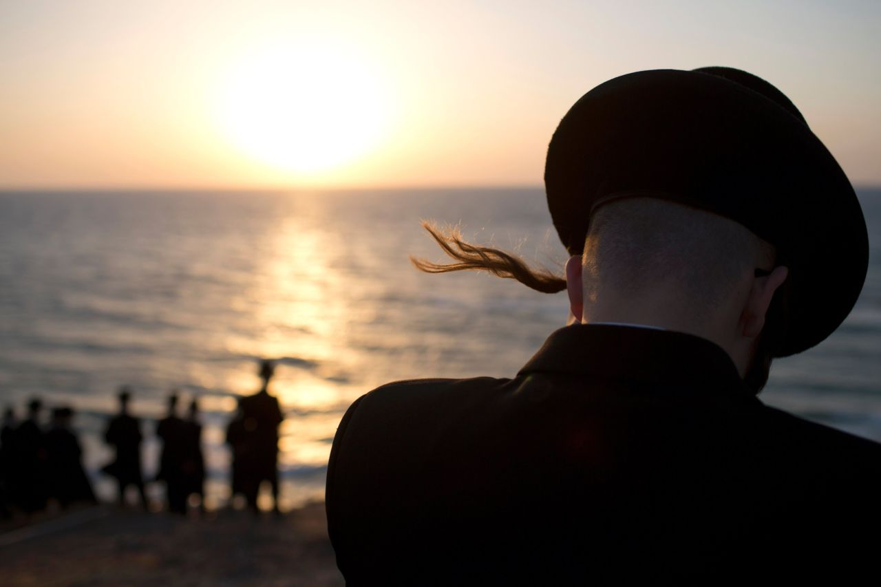 Ultra-Orthodox Jews of the Hasidic sect Vizhnitz gather on a hill overlooking the Mediterranean Sea as they participate in a Tashlich ceremony in Herzeliya, Israel.