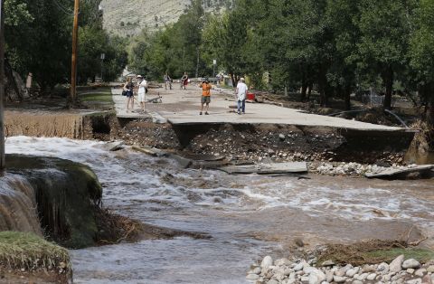 Water rushes where a bridge collapsed in a flash flood in Lyons, on September 13. 