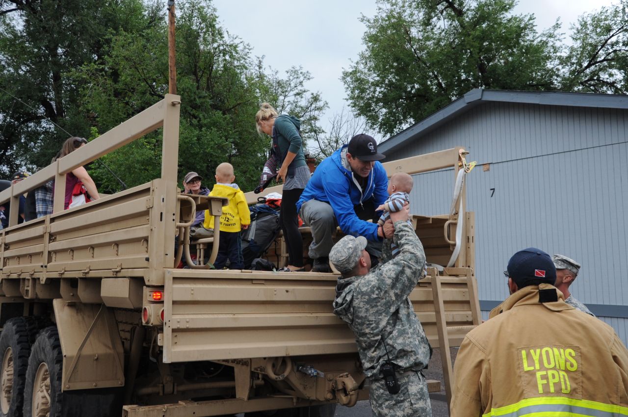 Members of the Colorado National Guard help Boulder County authorities evacuate residents of Lyons, Colorado, to Longmont, Colorado, on Friday, September 13.  Flooding has hit the area hard, washing out roads, damaging bridges and destroying homes. 