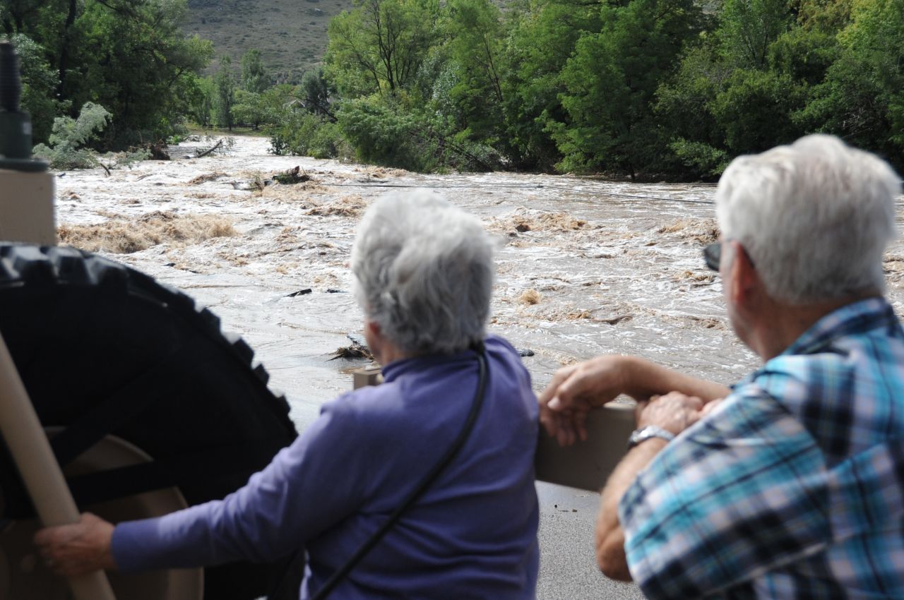 Dick and LaRue Vodime, temporary residents of Lyons, witness some of the destruction from the floods as they are evacuated to Longmont on September 13.