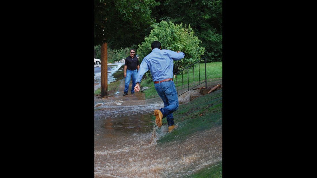 A man runs through the floodwaters in a yard in Boulder on September 13. 