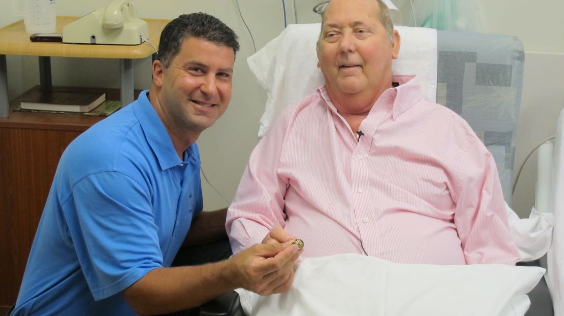 Brian Tovin returns the long-lost college ring to Robert Phillips.