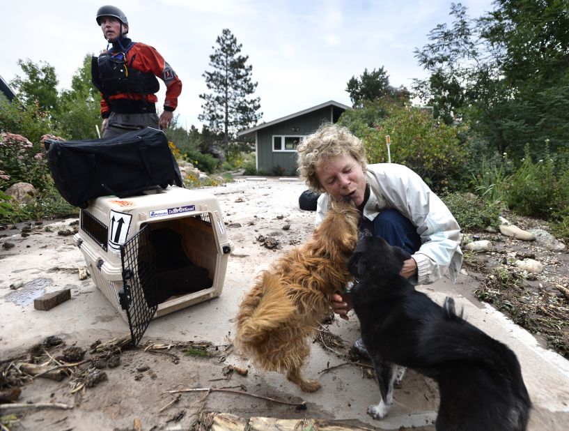 Suzanne Sophocles hugs her dogs after they were rescued from her flooded home on September 13 in Boulder. Thousands of people stranded by the flood waters in Colorado were finally able to come down by trucks and helicopters, two days after seemingly endless rain turned normally scenic rivers and creeks into coffee-colored rapids that wrecked scores of roads and wiped out neighborhoods. 