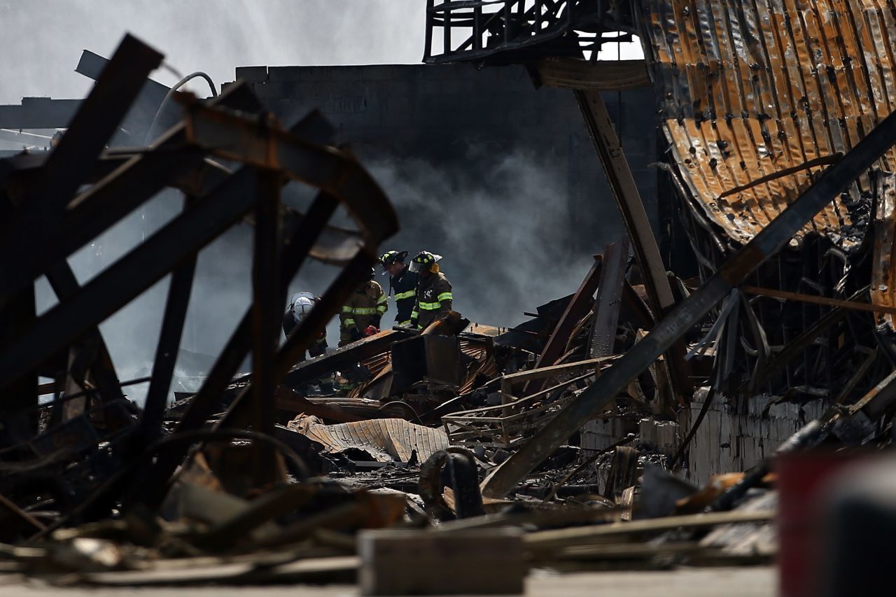Firefighters walk through the destroyed businesses on the boardwalk on September 13.