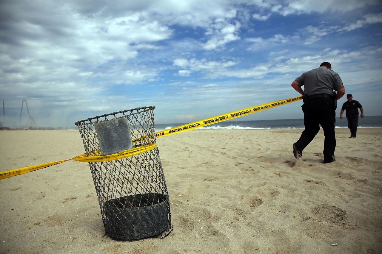 Police officers put up crime tape to keep people away from the destroyed remains of businesses along the boardwalk on September 13.