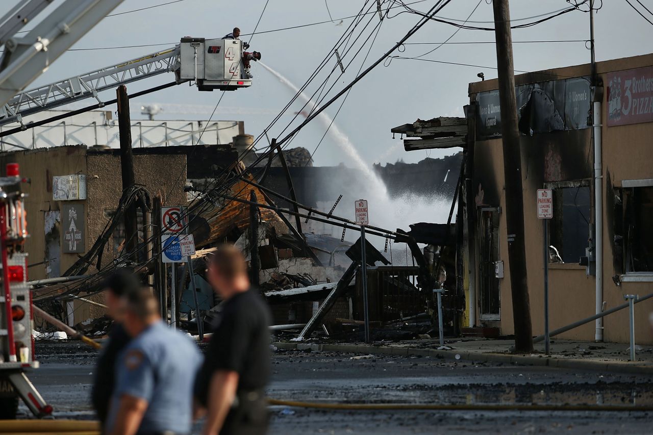 A firefighter sprays water on a hot spot on September 13.
