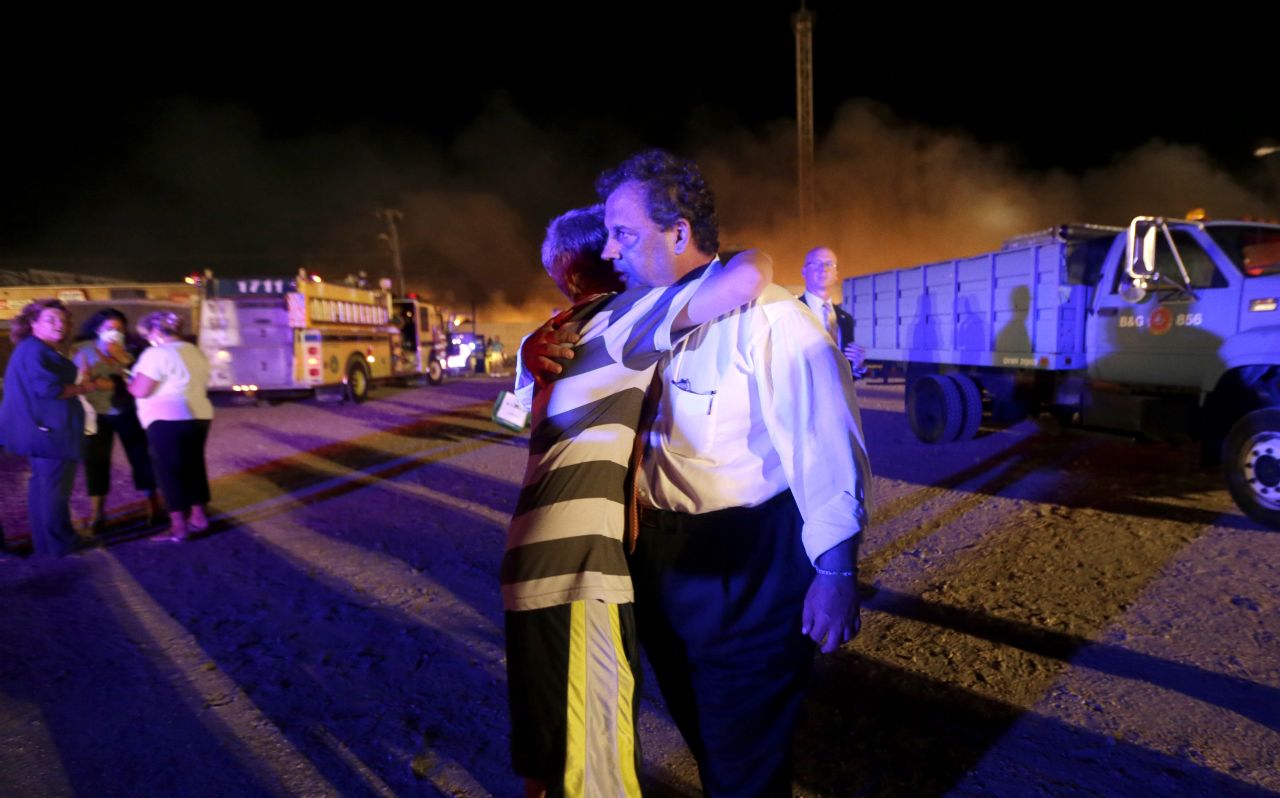 Christie is hugged by Michael Cisneros, 14, during a visit to the area hit by the massive fire on the boardwalk on Thursday, September 12.