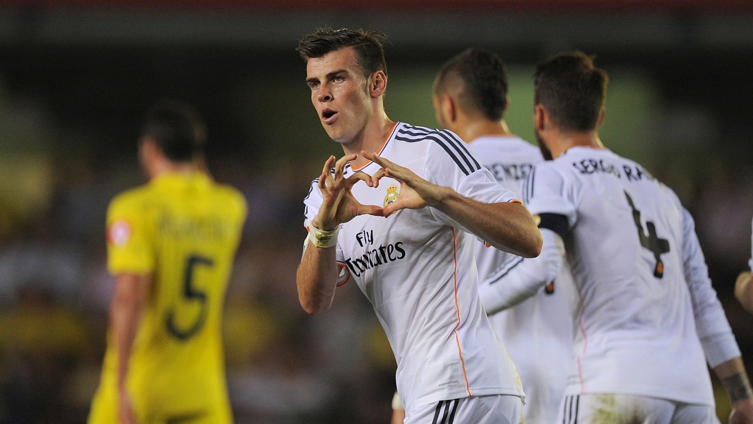 Gareth Bale's celebrates in trademark style after scoring on his Real Madrid debut against Villarreal. 