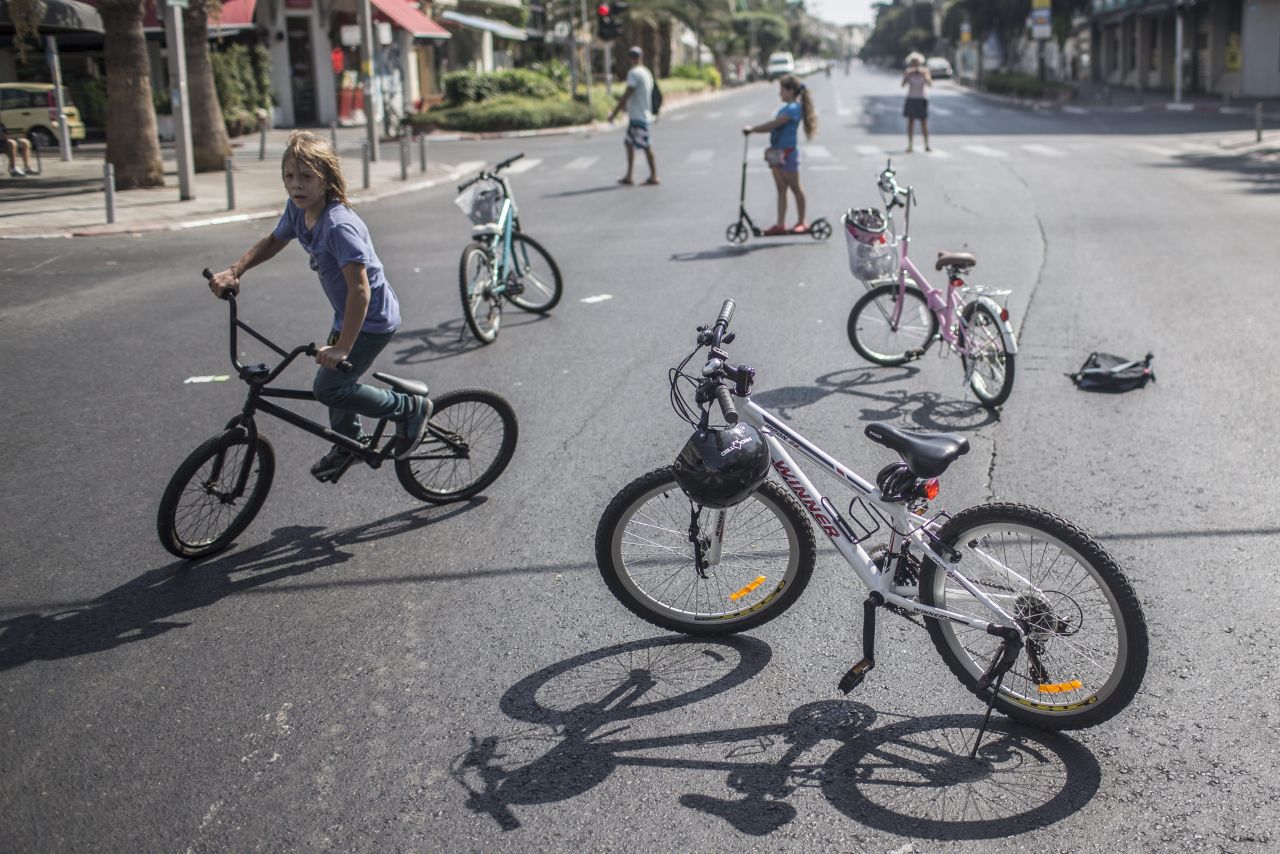 Israeli children ride their bikes on an empty street during Yom Kippur in Tel Aviv.