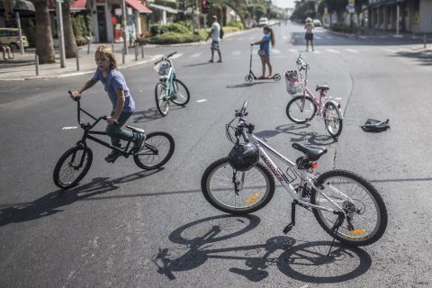 Israeli children ride their bikes on an empty street during Yom Kippur in Tel Aviv.