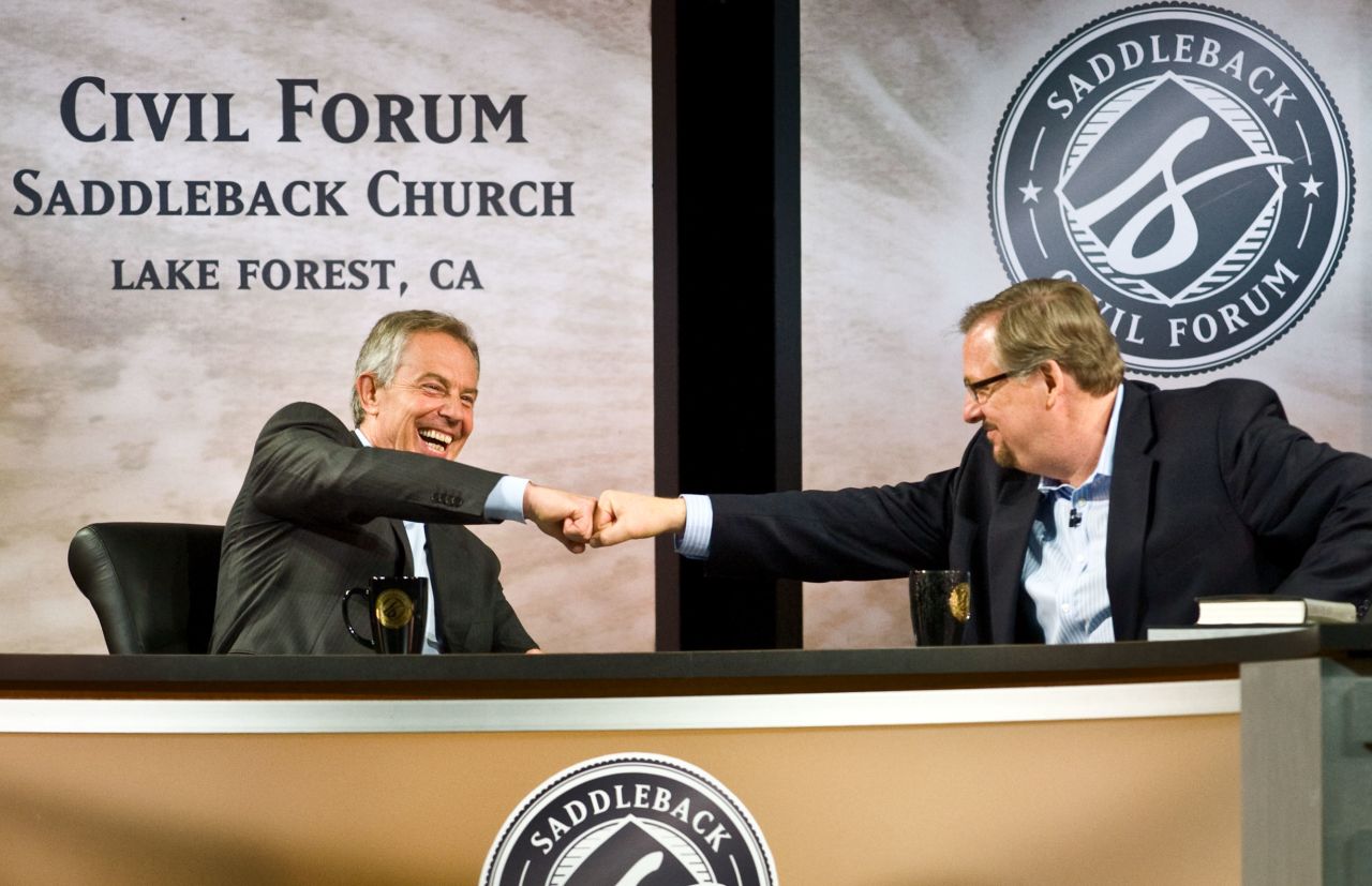 Former British Prime Minister Tony Blair and Warren fist-bump during the "Civil Forum on Peace in a Globalized Economy" at Saddleback Church on March 6, 2011.