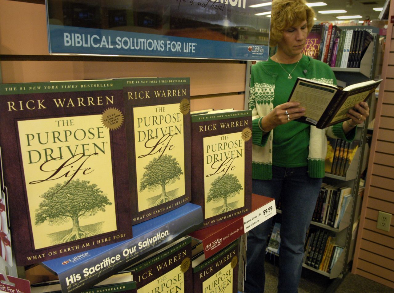 A woman flips through Warren's "The Purpose Driven Live" in a Christian bookstore in Atlanta in 2005. Interest in the book surged that year after Ashley Smith read portions of the book to murder suspect Brian Nichols as he held her captive in her suburban Atlanta apartment and persuaded him to surrender.