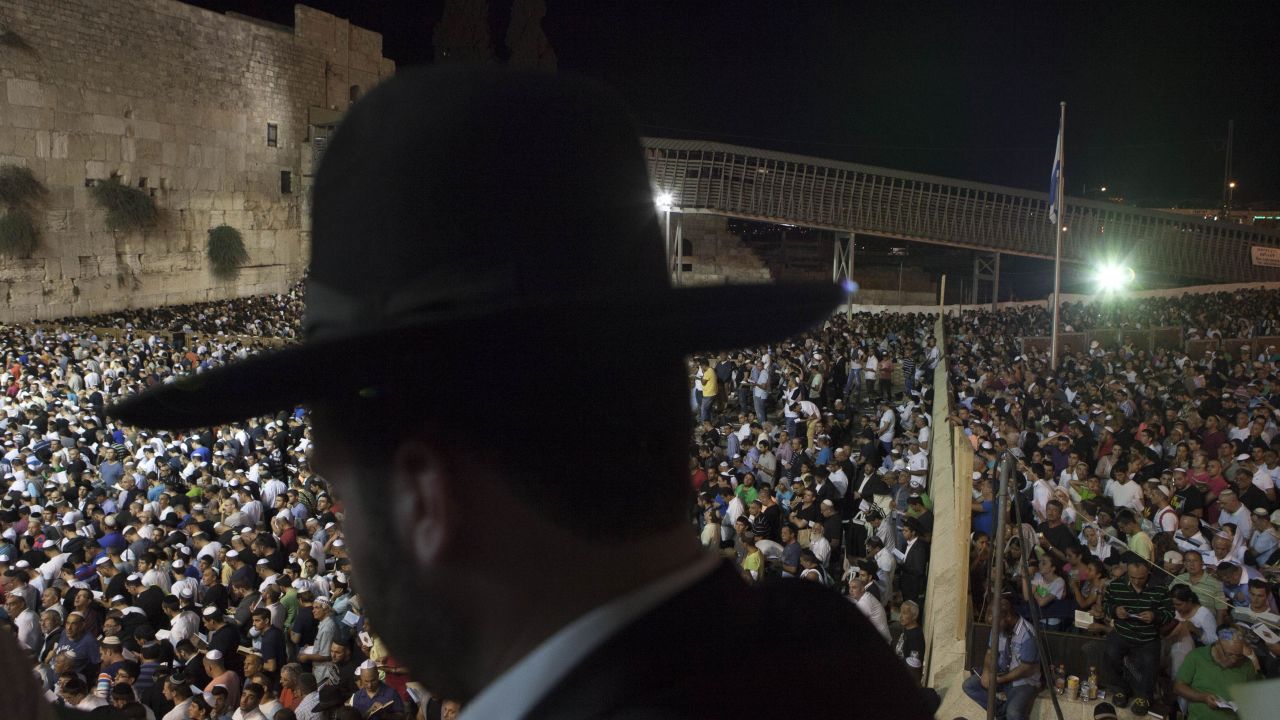 Men and women participate in a Selichot prayer ahead of the Jewish holiday of Yom Kippur at the Western Wall in Jerusalem. Selichot is Hebrew for forgiveness.