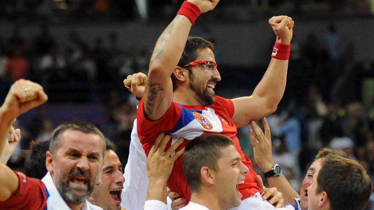 The Serbian team celebrate with Janko Tipsarevic after he lifted them to a 3-2 win over Canada.  