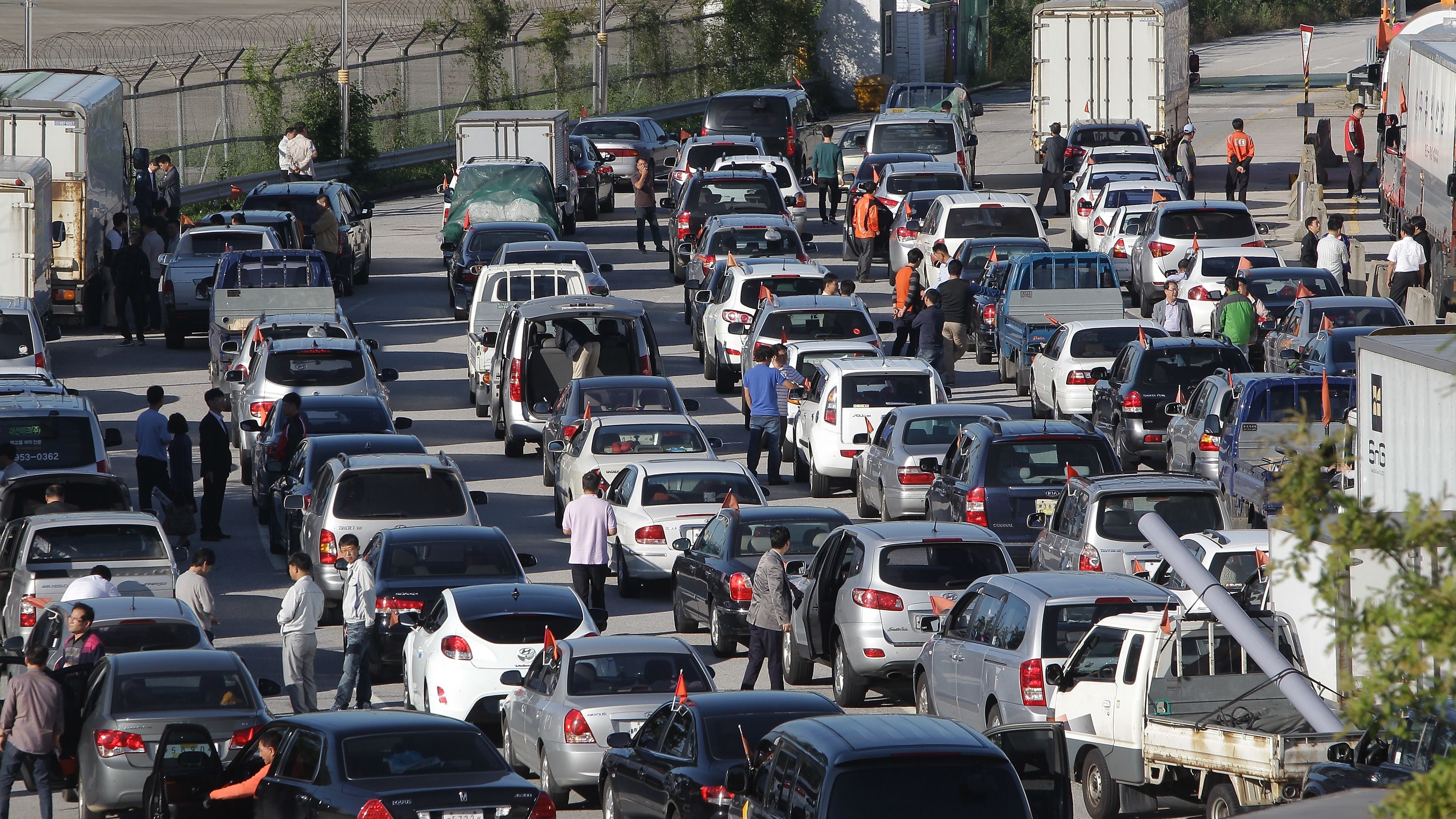 South Korean owners and workers wait in traffic to cross into Kaesong. 