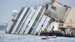 Members of the US salvage company Titan and Italian firm Micoperi work at the wreck of Italy's Costa Concordia cruise ship near the harbour of Giglio Porto on September 16, 2013. Salvage workers will attempt to raise the cruise ship today, in the largest and most expensive maritime salvage operation in history, so-called 'parbuckling', to rotated the ship by a series of cables and hydraulic machines. Thirty-two people died when the ship, with 4,200 passengers onboard, hit rocks and ran aground off the island of Giglio on January 2012. AFP PHOTO / ANDREAS SOLARO (Photo credit should read ANDREAS SOLARO/AFP/Getty Images)