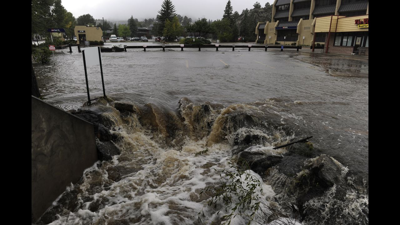 Water pours out of a parking lot, overwhelming a culvert heading under the roadway, in Estes Park, Colorado, on September 15.