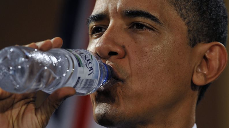 President Barack Obama drinks from a bottle of water during a news conference at the Foreign and Commonwealth Office in London on April 1, 2009.  