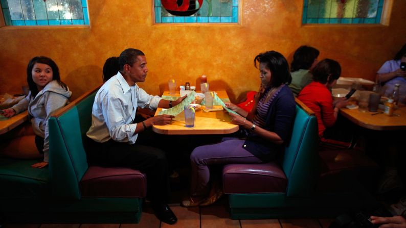 During the 2008 presidential campaign, the Obamas drink water as they study the menu at Jorge's Sombrero restaurant in Pueblo, Colorado. 
