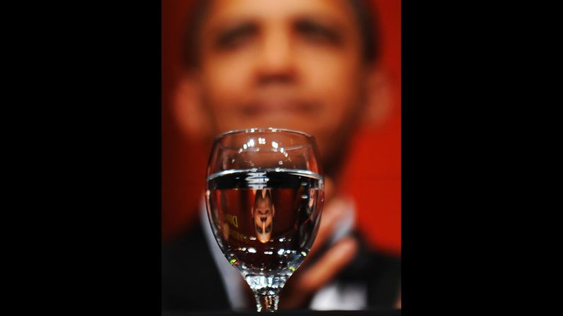 Obama is reflected on a glass of water as he sits at the Radio and Television Correspondents' Association Dinner in Washington on June 19, 2009. 
