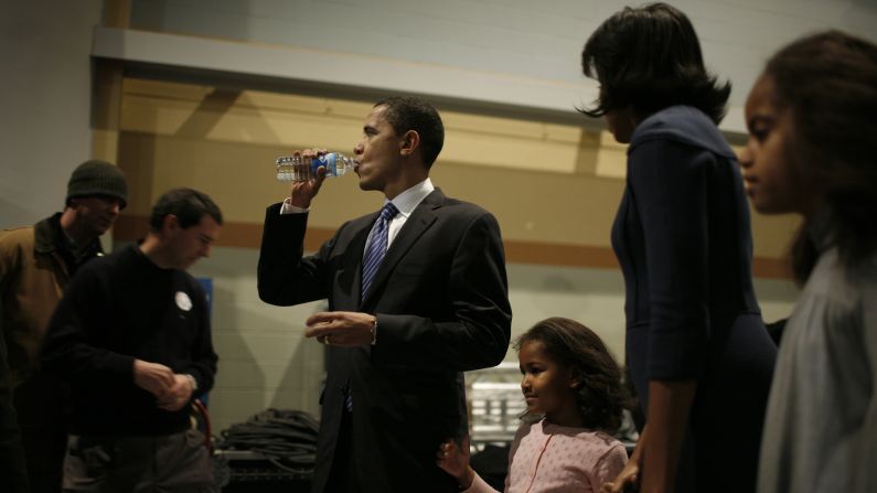 Obama stays hydrated backstage with his family at Hy-Vee Hall in Des Moines, Iowa, on January 3, 2008. 