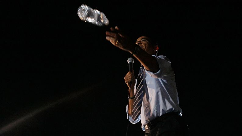 Obama throws a bottle of water into the audience while speaking at a rally in Indianapolis in May 2008.