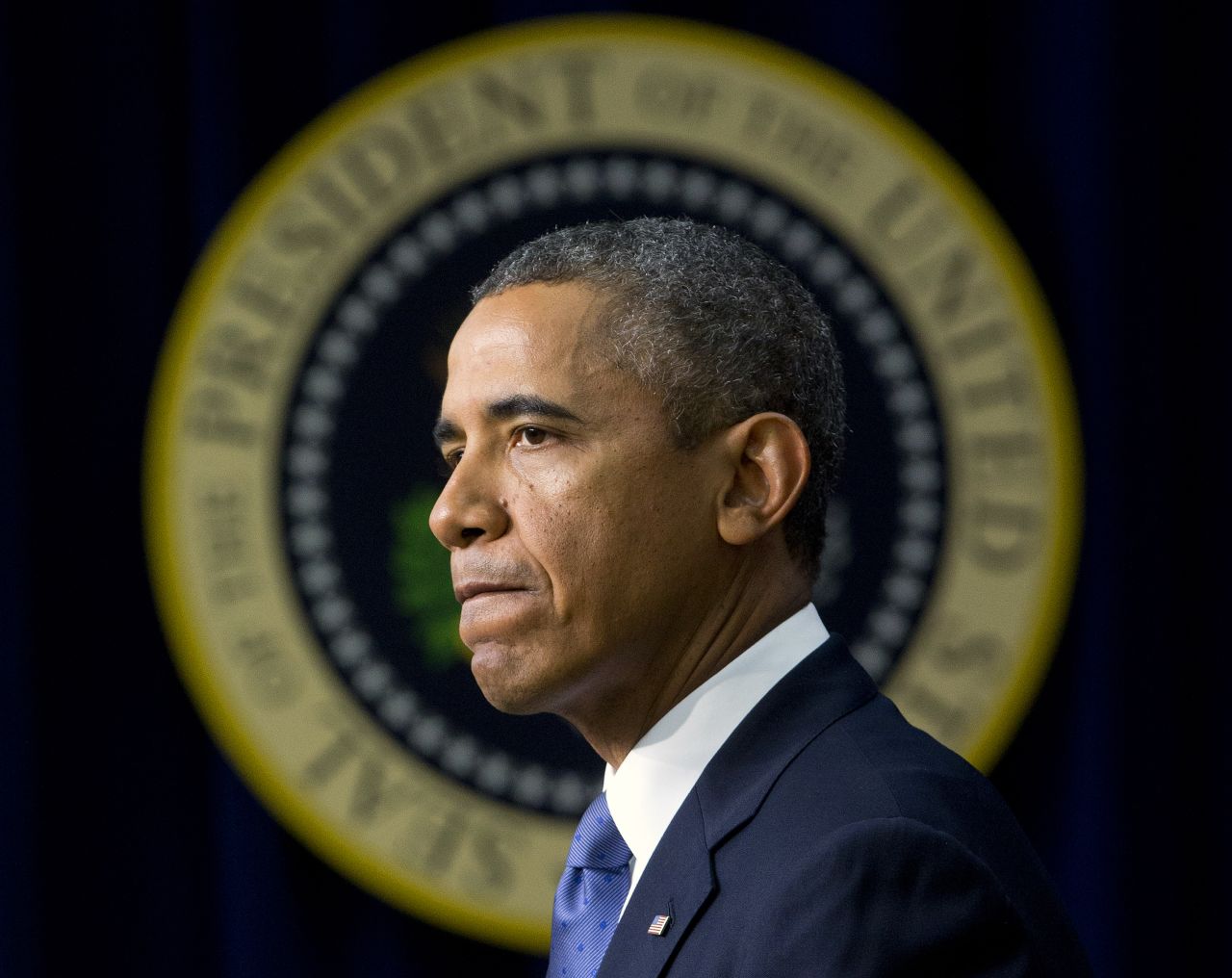 Obama pauses as he speaks in September 2013 about the shooting at the Washington Navy Yard, mourning what he called "yet another mass shooting" that took the life of American patriots. 