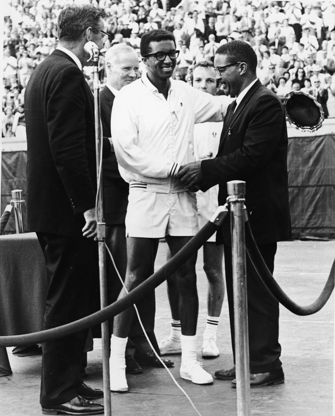 Five years before his win at Wimbledon, Ashe won the U.S. Open  title at Forest Hills in New York. Here he receives the congratulations of his father Arthur Ashe Senior after winning the U.S. grand slam.