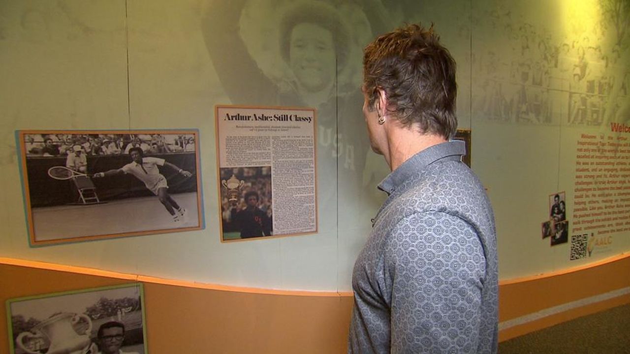 Fellow tennis great Pat Cash examines exhibits in the Arthur Ashe Learning Center in New York which highlight the life and works of the grand slam champion.   