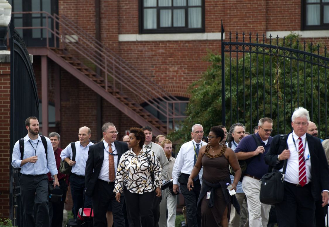 Workers who had been sheltered during a lockdown exit the Navy Yard.