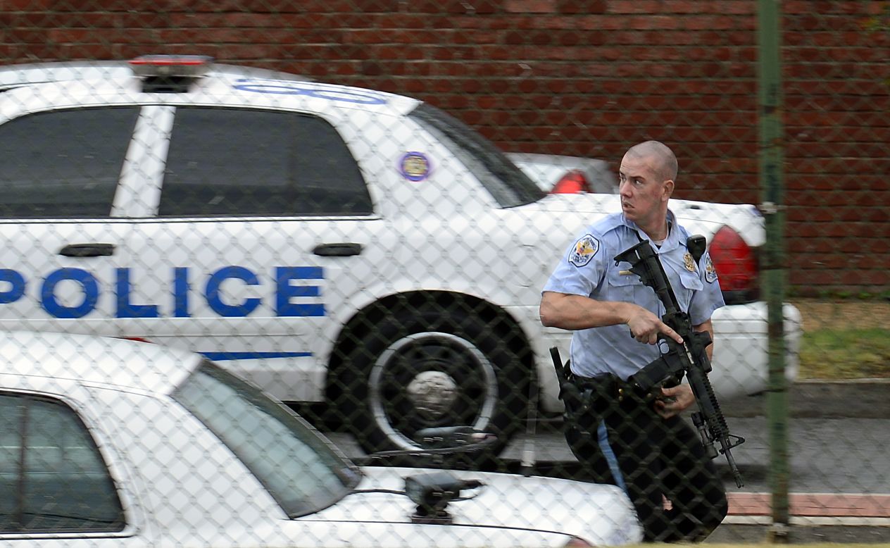 A police officer runs near the scene of the shooting rampage at the Washington Navy Yard on Monday, September 16, 2013. Authorities said at least 12 people -- and the suspect -- were killed in the shooting.