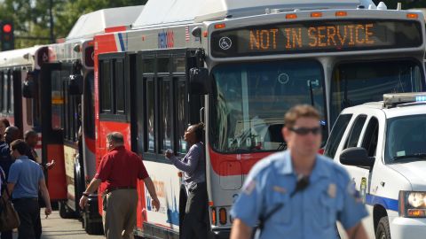 People step off buses at Parking Lot B of Nationals Park, which was set up as a gathering point for family members of Navy Yard employees in the wake of the shooting.