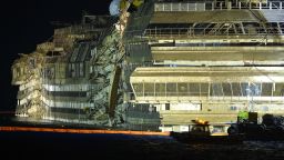 The wreck of Italy's Costa Concordia cruise ship begins to emerge from water on September 17, 2013 near the harbour of Giglio Porto. Salvage workers attempt to raise the cruise ship today and tonight, in the largest and most expensive maritime salvage operation in history, so-called 'parbuckling', rotating the ship by a series of cables and hydraulic machines. Thirty-two people died when the ship, with 4,200 passengers onboard, hit rocks and ran aground off the island of Giglio on January 2012. AFP PHOTO / ANDREAS SOLARO (Photo credit should read ANDREAS SOLARO/AFP/Getty Images)