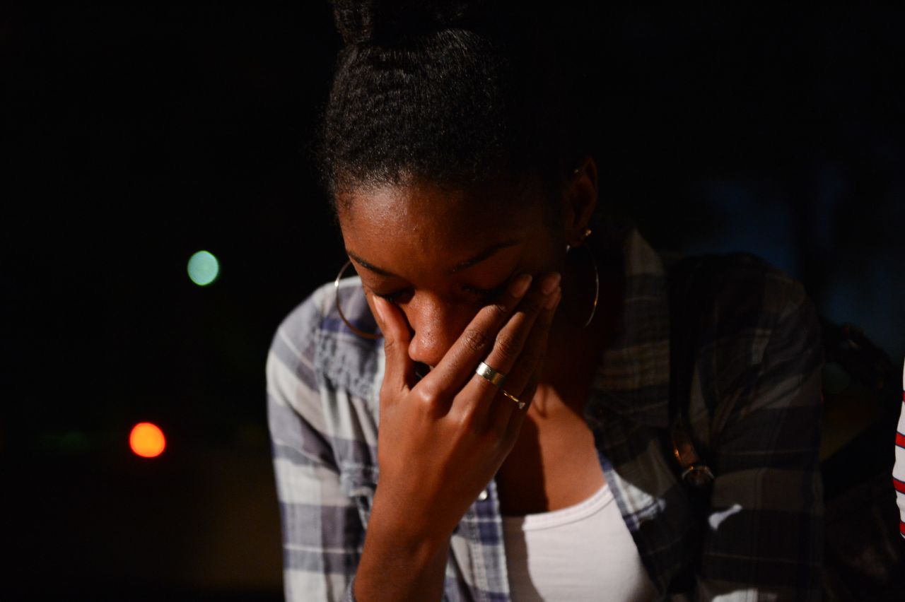 Brittany Carter wipes tears away at the September 16 vigil.