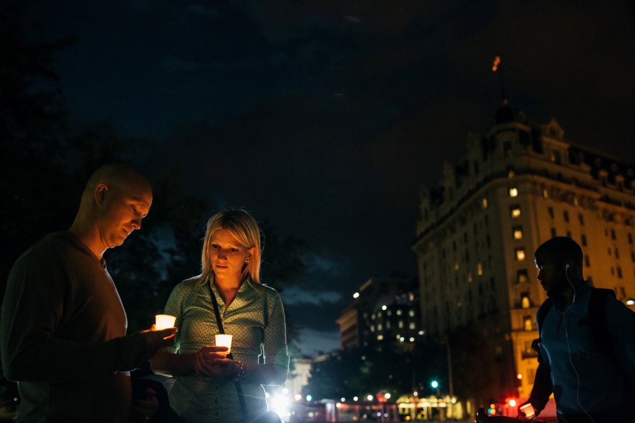 Dave Gray and his wife, Brittany, of Salt Lake City hold candles in remembrance of people affected by gun violence.