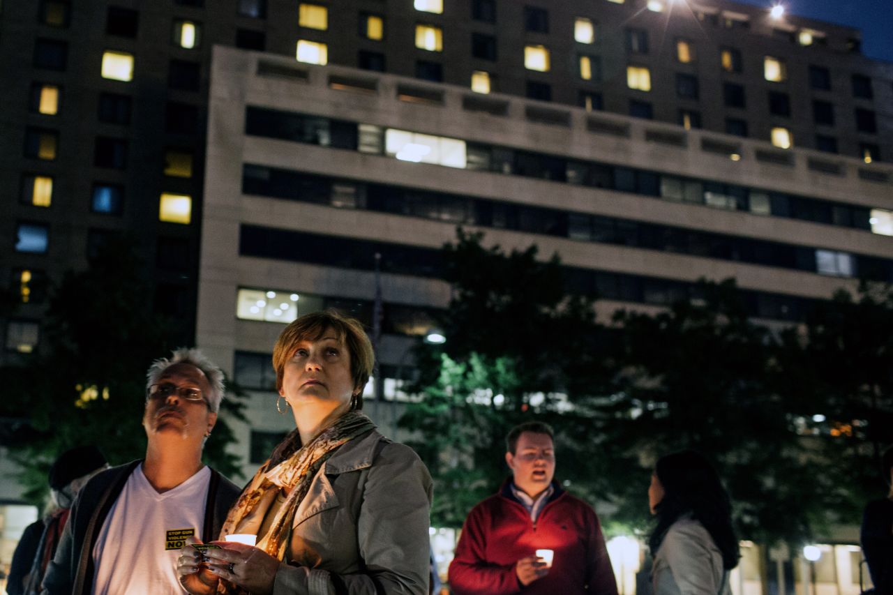 Gordon Morris, left, and wife Laura watch as flags are lowered to half-staff during the September 16 vigil at Freedom Plaza.