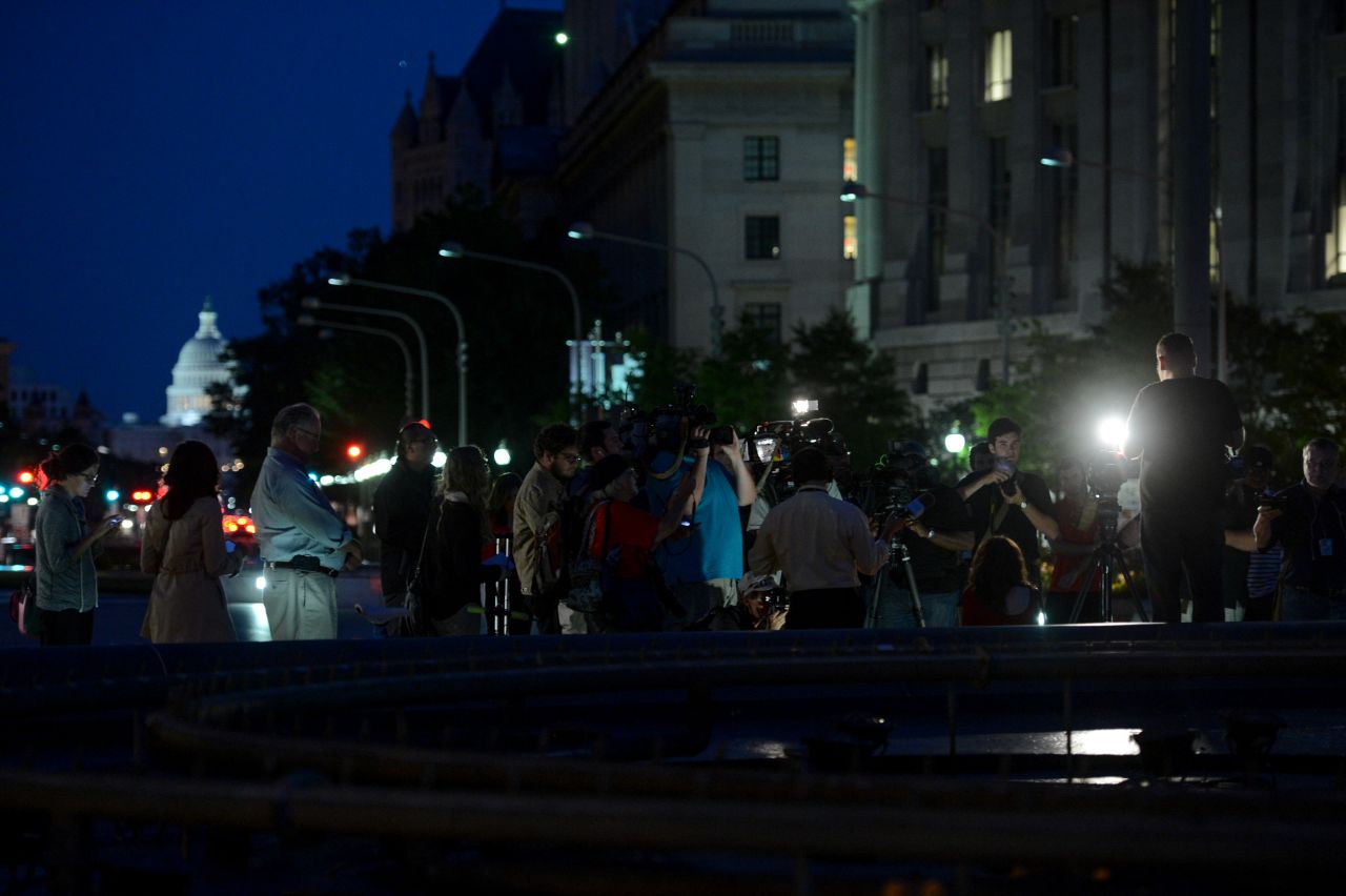 Members of the media cover the vigil on September 16.