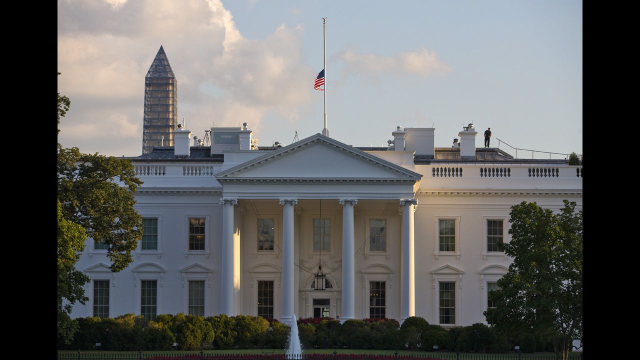 The U.S. flag flies at half-staff above the White House the day of the deadly shooting.