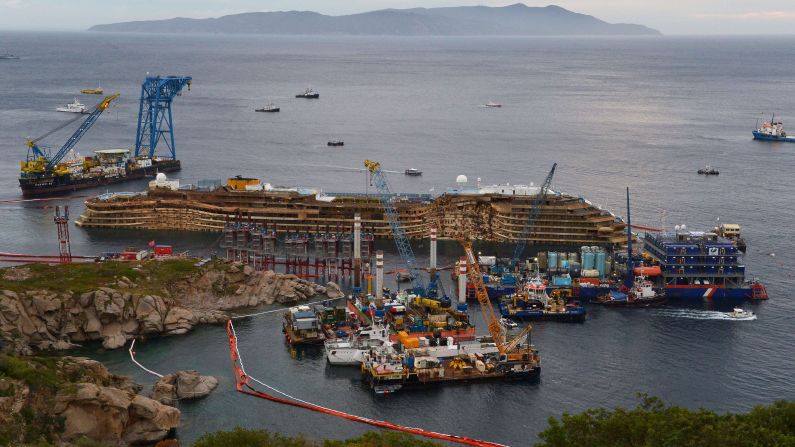 The wreckage of the Costa Concordia cruise ship sits near the harbor of Giglio on Tuesday, September 17, after a <a href="index.php?page=&url=https%3A%2F%2Fwww.cnn.com%2F2013%2F07%2F18%2Feurope%2Fgallery%2Fcosta-concordia%2Fwww.cnn.com%2F2013%2F09%2F15%2Fworld%2Feurope%2Fitaly-costa-concordia-salvage%2Findex.html" target="_blank">salvage crew rolled the ship off its side</a>. 
