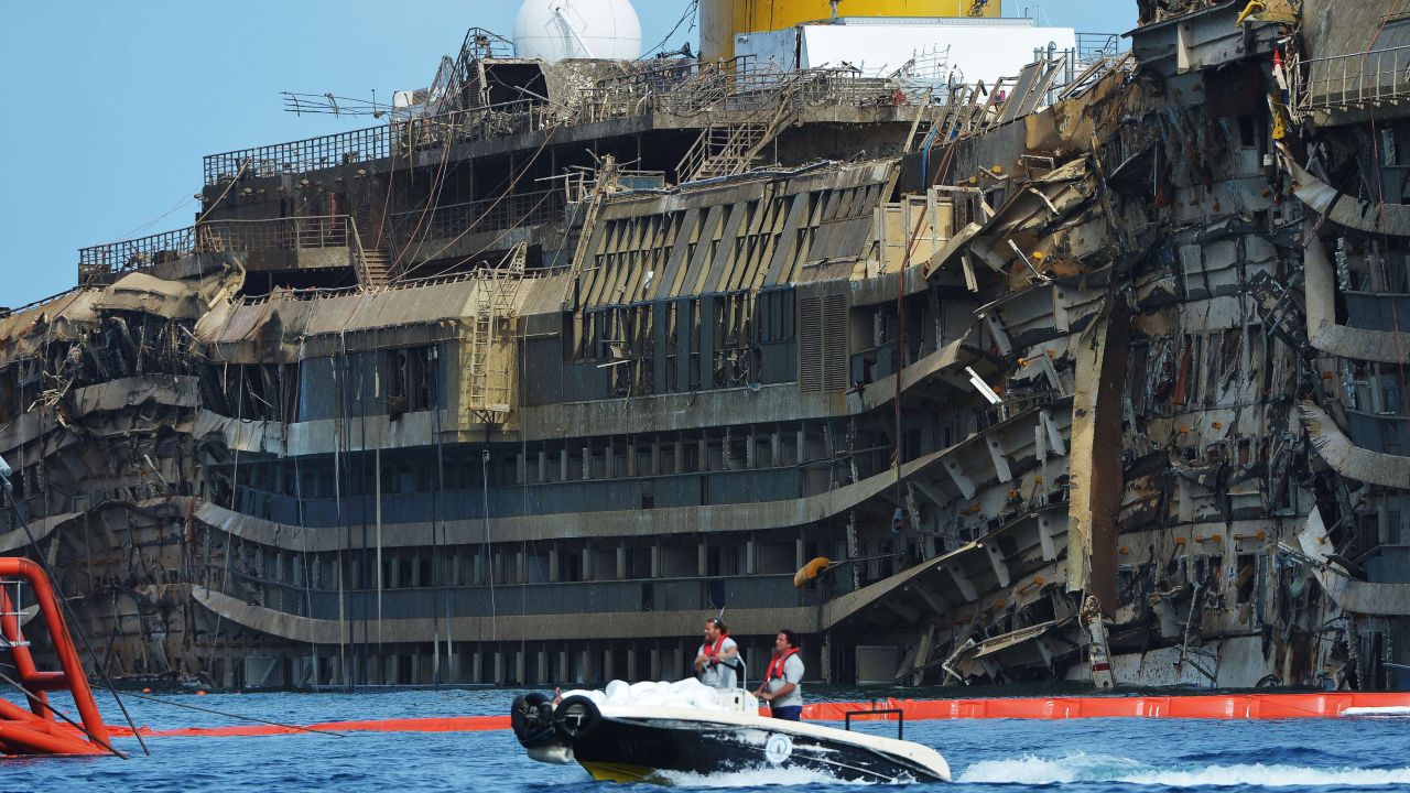 The ship had been lying on its side for 20 months off the island of Giglio. Here, members of the U.S. company Titan Salvage and the Italian marine contractor Micoperi pass by the wreckage.