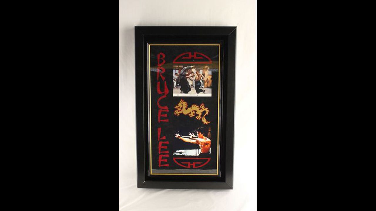 Double framed and matted 8-by-10-inch color photo from "Fist of Fury" movie, autographed "Bruce Lee."