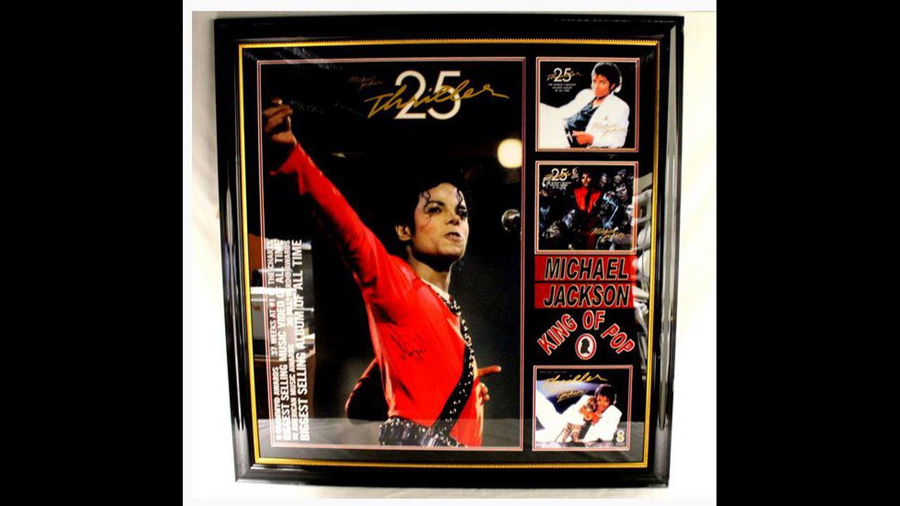 Framed and matted poster for 25th anniversary of "Thriller," autographed "Michael Jackson." 